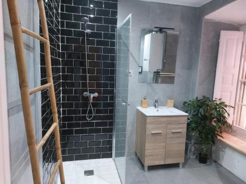 a bathroom with a shower with a sink and a mirror at Getxo Beach Apartment by Getxo Garden Houses in Getxo