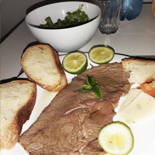 a plate of food with a piece of meat and bread at Casa Giada sul mare in Torrenova