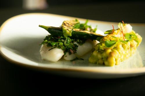 a plate of food with seafood and vegetables on it at Hotel Le Lion D'Or et Restaurant La Table Du Lion in Bayeux