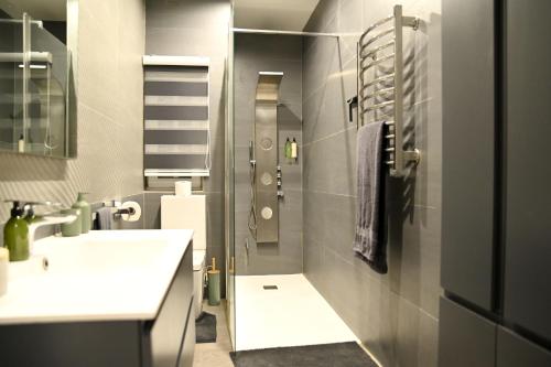 a bathroom with two sinks and a shower in it at 2 Bedroom Luxury Apartment in Madliena Swieqi in Is-Swieqi