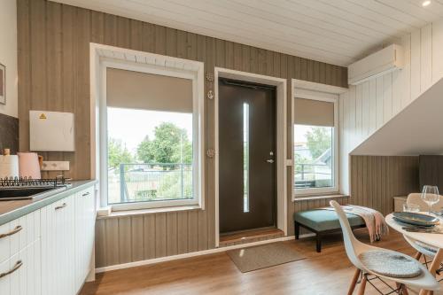 a kitchen with a door and a table and chairs at Lapmanni Studios in Haapsalu