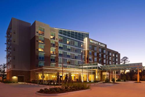 a large building with a sign on the front of it at Hyatt Place Houston/The Woodlands in The Woodlands