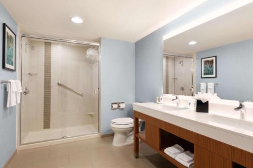 a bathroom with a sink and a toilet and a shower at Hyatt Place Houston/The Woodlands in The Woodlands