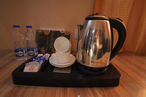 a coffee maker sitting on a black tray on a table at Tulsi Garden- Near Prem Mandir Vrindavan in Vrindāvan