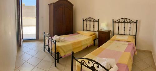 Postel nebo postele na pokoji v ubytování Villetta Maldive Salento