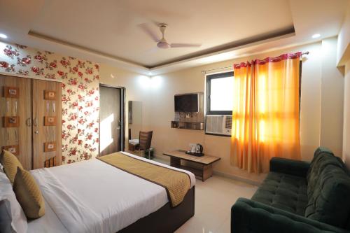 a hotel room with a bed and a couch at Tulsi Garden- Near Prem Mandir Vrindavan in Vrindāvan