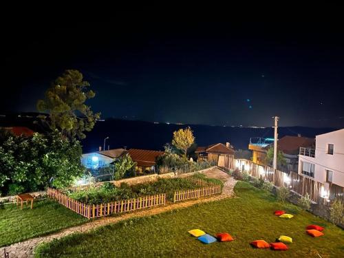 a yard with several frisbees on the grass at night at Limonlu Bahçe Butik Otel in Karaburun