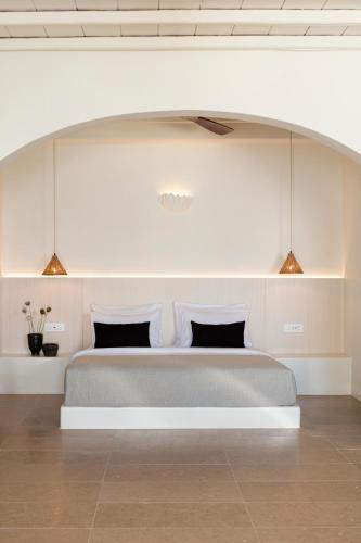 a bedroom with a large bed in a room at Porto Mykonos in Mýkonos City