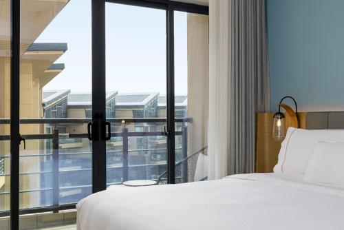 a hotel room with a bed and a large window at Element Xiamen Tong'an in Xiamen