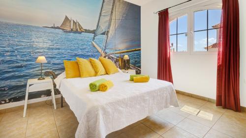 a bedroom with a large bed with a sail on it at Chalet Mar in Caleta De Fuste