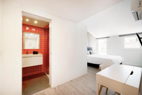a small room with a bed and a bathroom at Lisbon Oriente Suites by Olala Homes in Lisbon