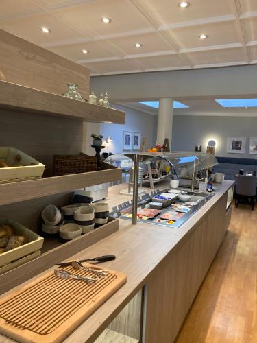 a kitchen with a counter top with some food at elaya hotel hannover city in Hannover
