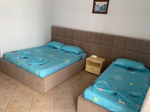 a bedroom with two beds and a couch at Armando Home-Free Parking Included in Vlorë