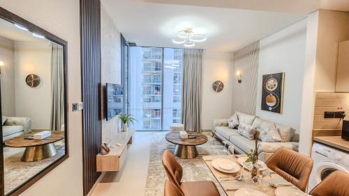 a living room with a couch and a table at STAY BY LATINEM Luxury 1BR Holiday Home CV B905 near Burj Khalifa in Dubai