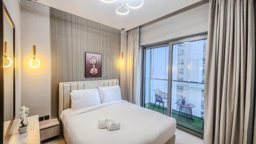 a bedroom with a bed and a large window at STAY BY LATINEM Luxury 1BR Holiday Home CV B905 near Burj Khalifa in Dubai