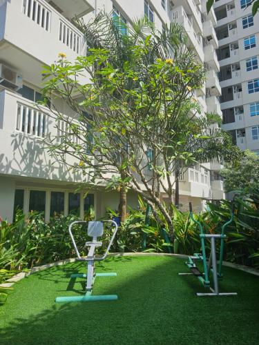 a yard with exercise equipment in front of a building at Apartemen Borneo bay city in Balikpapan