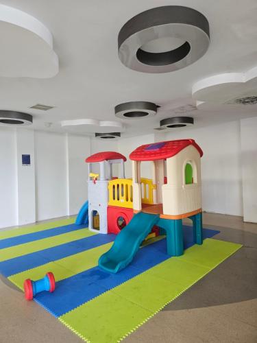 a play room with a slide and a playground at Apartemen Borneo bay city in Balikpapan