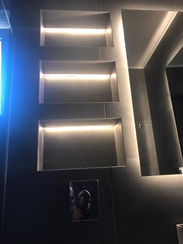 a person taking a picture in a bathroom with a mirror at Edem in Vatera