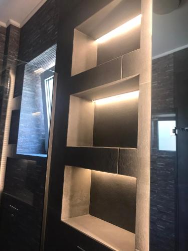 a wall with shelves in a bathroom with a window at Edem in Vatera