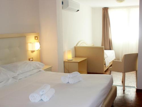 Postel nebo postele na pokoji v ubytování Hotel Rio Sanremo
