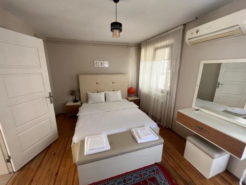a small bedroom with a bed and a mirror at KazanciApart15 in Istanbul