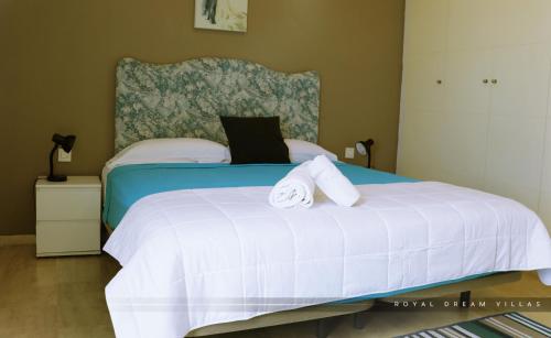 a bedroom with a bed with two towels on it at Royal Dream Villas in Adeje