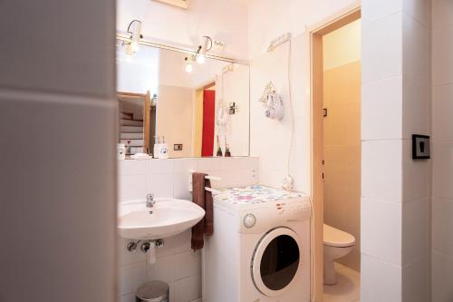 a bathroom with a washing machine and a sink at Harbor Central Place in Hvar