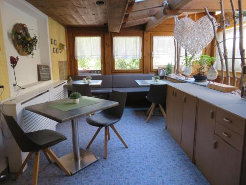 a kitchen with a table and chairs in a room at Forsthaus Falkner in Sölden