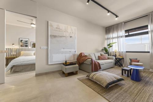 a living room with a couch and a bed at La casa de las velas in Playa Honda