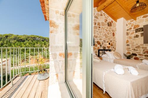 a bedroom with a view of the balcony of a house at Misovounous Natural Park Villa by "elite" in Agios Leon