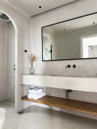a bathroom with a sink and a mirror at Agapitos Villas & Guesthouses in Agios Ioannis Pelio