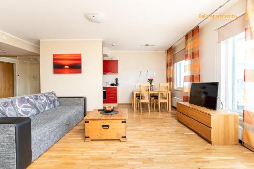 a living room with a couch and a tv at Daily Apartments - Viru Keskus in Tallinn