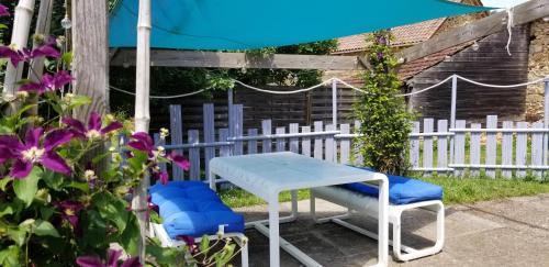 - une table, des chaises et un parasol dans le jardin dans l'établissement Romantic Bijou Gite with shared pool, à Larzac