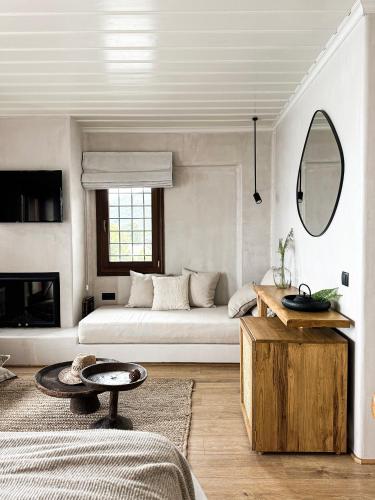 a white living room with a couch and a table at Agapitos Villas & Guesthouses in Agios Ioannis Pelio