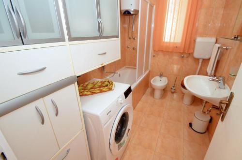 a bathroom with a washing machine and a sink at Central Art Oasis Kotor in Kotor