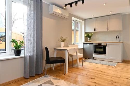 a kitchen with a table and chairs and a window at Private apartment in Pärnu