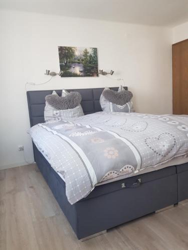 a bed with a blue bed frame in a bedroom at Mosel-Ina in Bullay