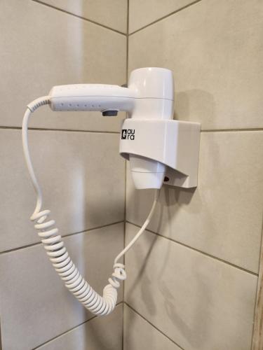 a white phone is hanging on a wall at HaPPy Inn Ugnė, The studio is in the heart of the old town, self-check-in, car-parking in Vilnius