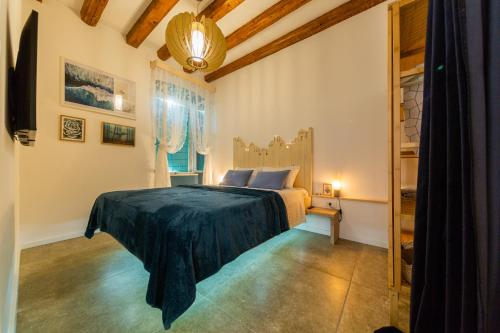 a bedroom with a bed and a chandelier at Just 4 You in Komiža