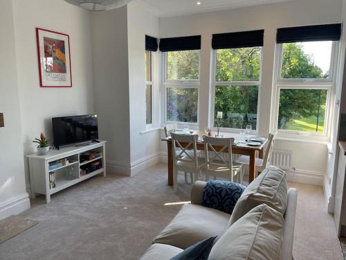 a living room with a couch and a dining room table at Beautiful apartment in Harrogate, North Yorkshire in Harrogate