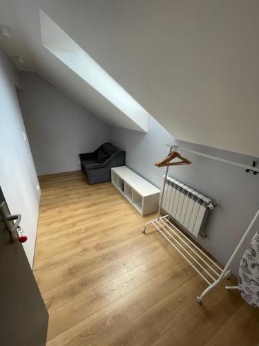 an attic room with a staircase and a couch at Apartament_Zbąszyń in Zbąszyń