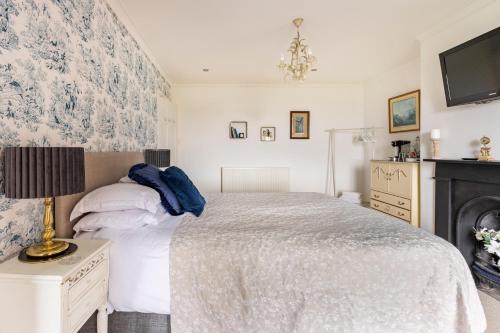 a bedroom with a bed and a fireplace at Penyvoel Hall in Llanymynech