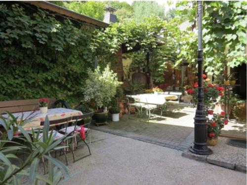 a garden with a table and chairs and a lamp post at Ferienwohnung Yuan in Bruchweiler-Bärenbach