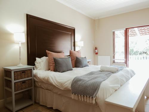 a bedroom with a large bed with a large headboard at Studio 14 @ The Dunes in Plettenberg Bay