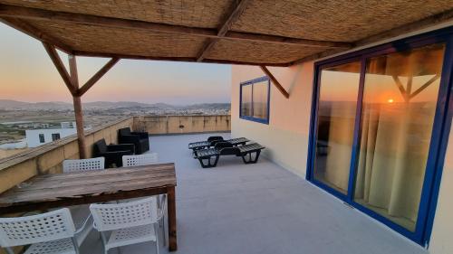 a balcony with chairs and tables on a building at Villa Serenity B&B in Sannat