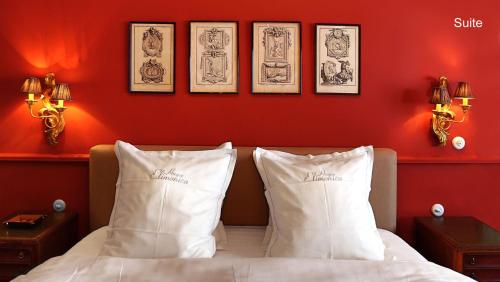 a bedroom with red walls and a bed with white pillows at B&B Huyze Elimonica in Ostend