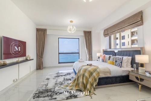a bedroom with a large bed and a large window at Manzil - Lavish 3BR in JBR with Sea Views and 5 min walk to beach in Dubai