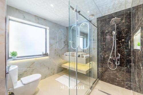 a bathroom with a shower and a toilet and a sink at Manzil - Lavish 3BR in JBR with Sea Views and 5 min walk to beach in Dubai