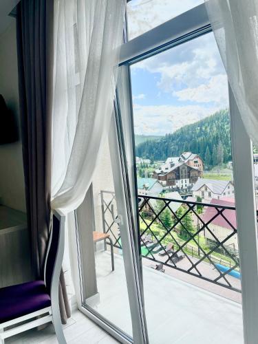 a view from a balcony with a window at Gold Palace SPA Resort Bukovel in Bukovel