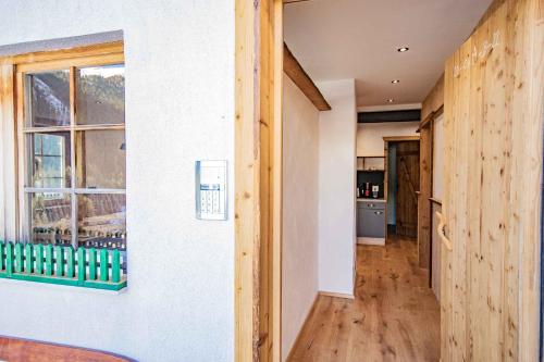 a hallway of a house with wooden floors and a window at Peerfect Ferienwohnungen in Navis